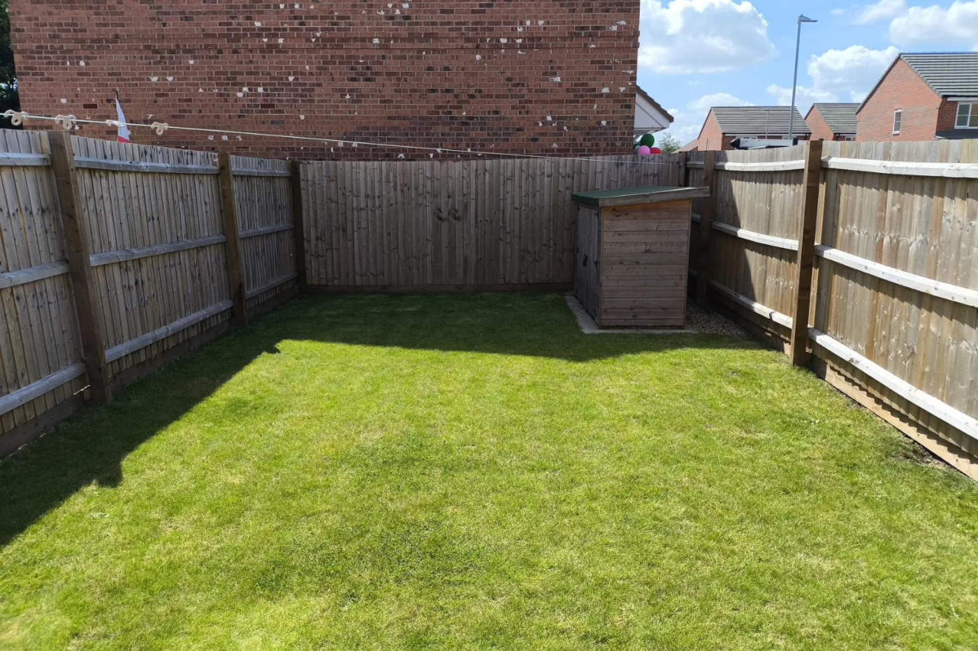 enclosed garden with a small shed