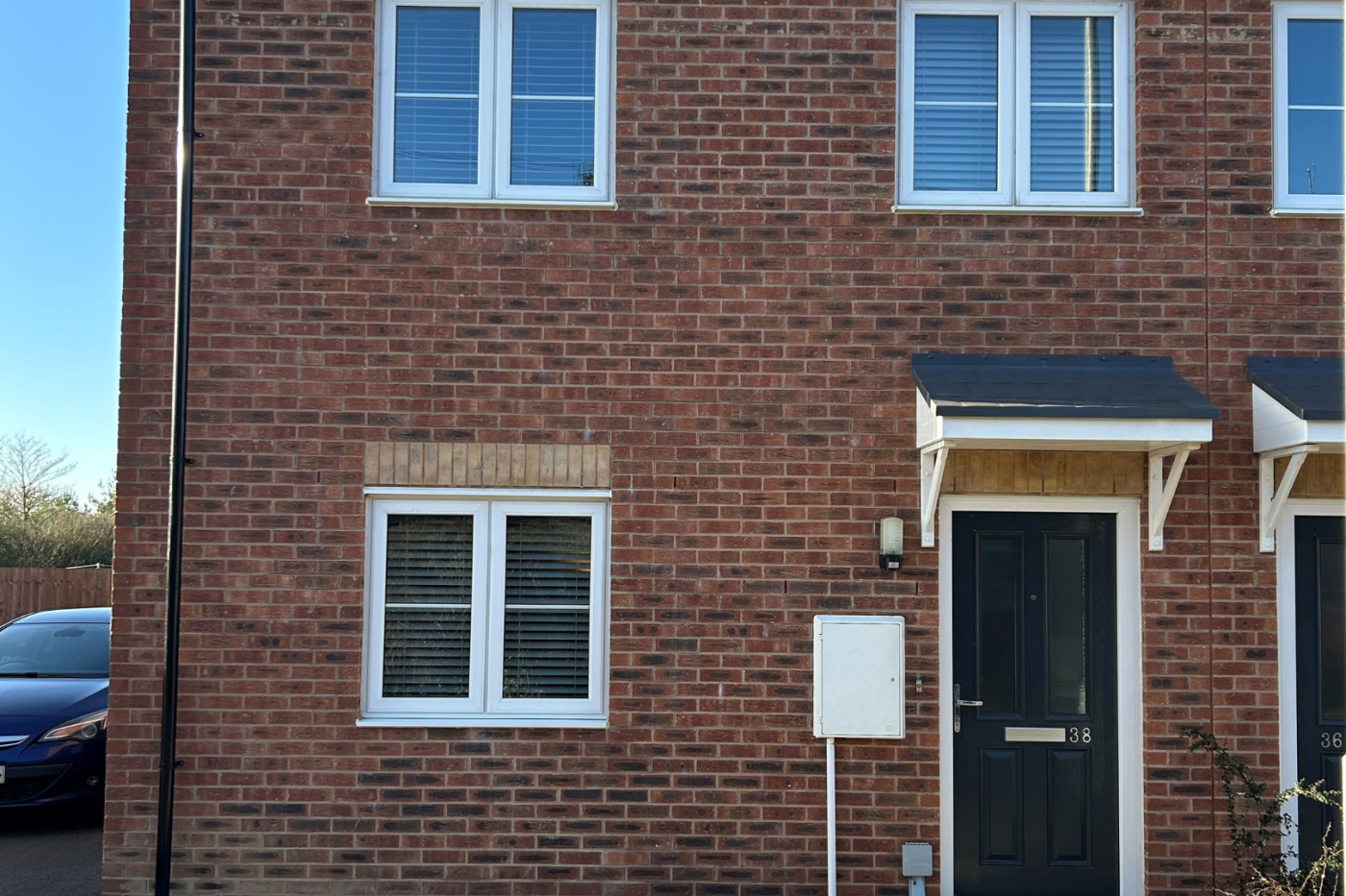 Front of a semi detached house with a driveway