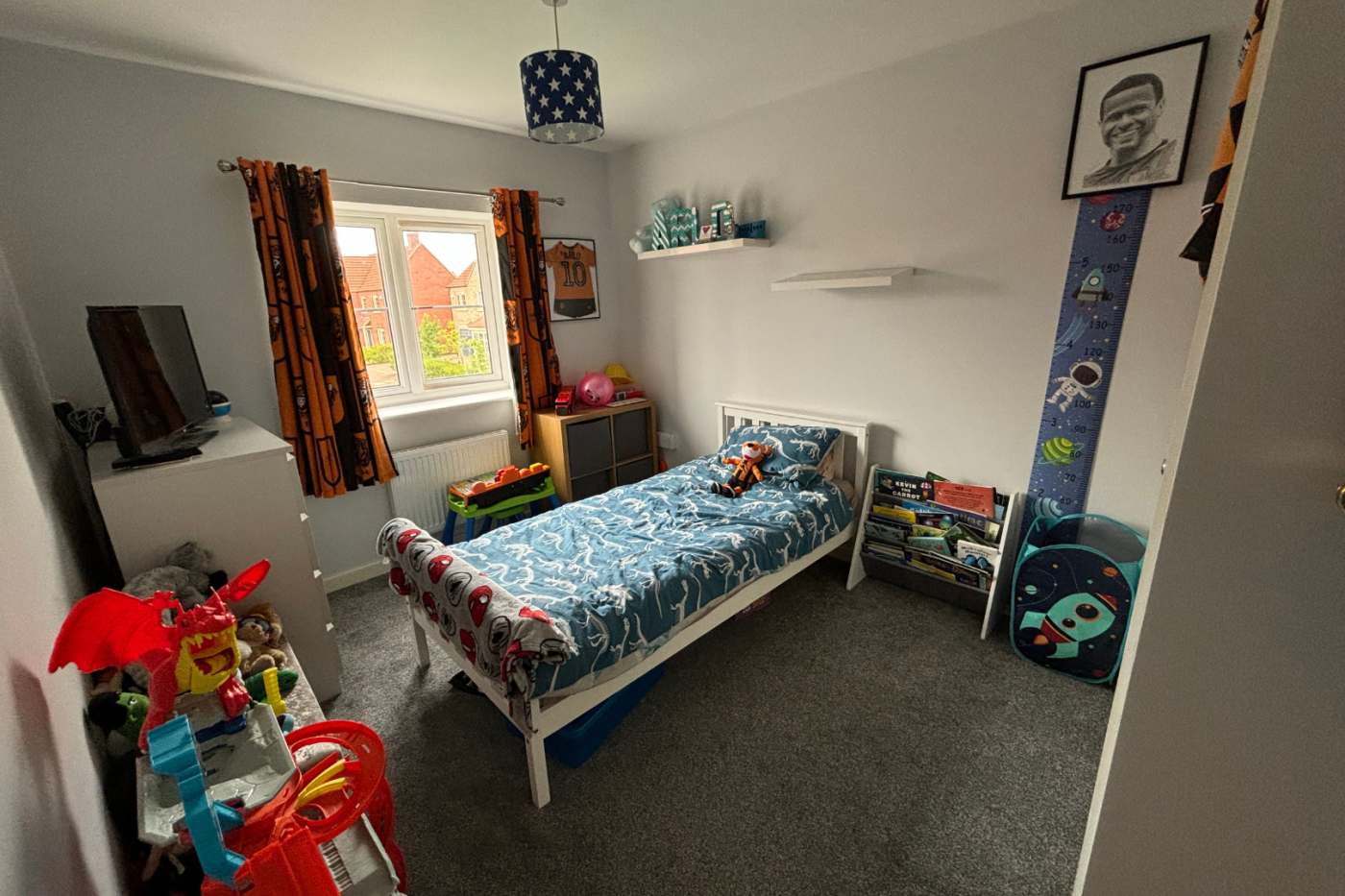 Kids bedroom with a single bed and toys