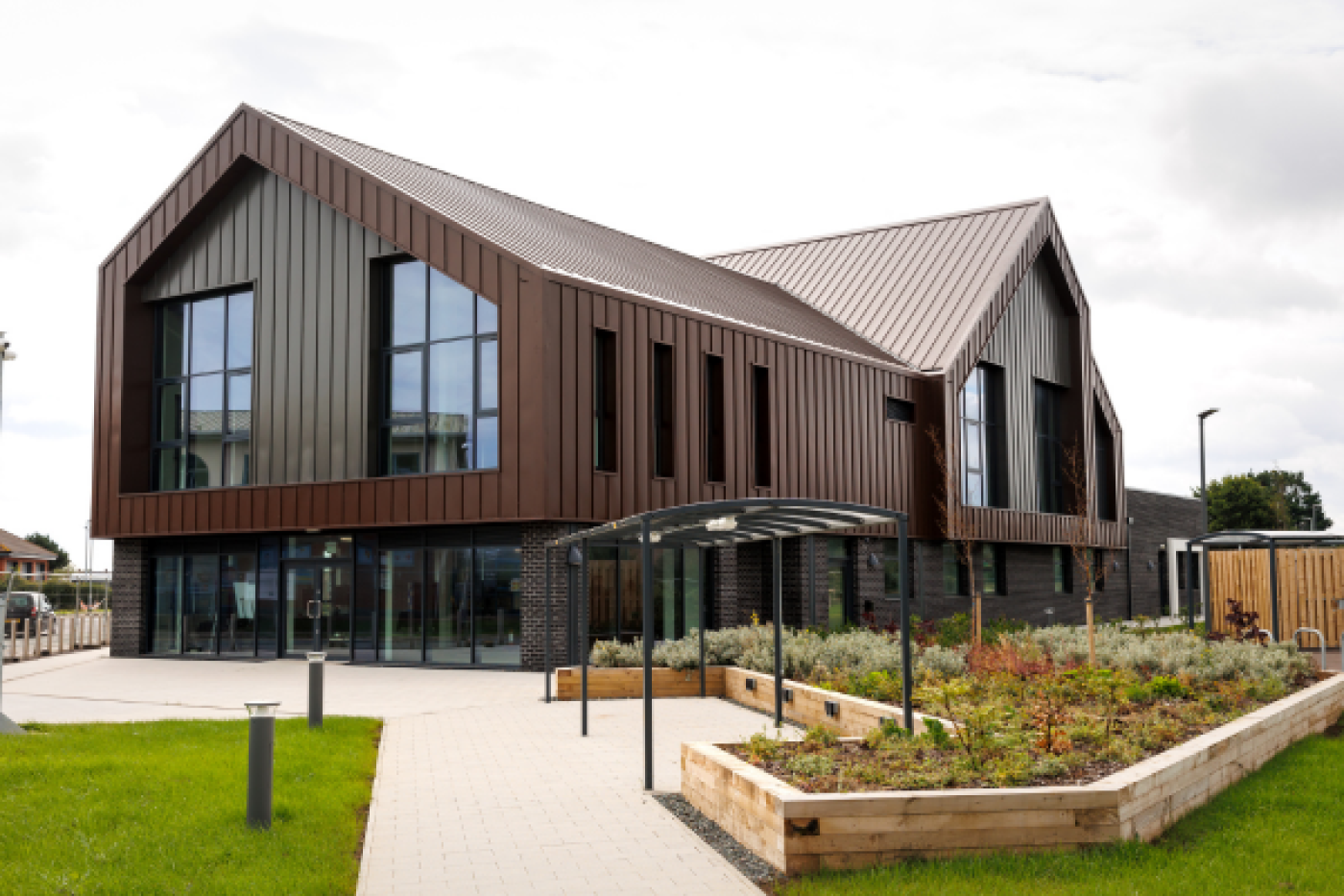 A building with greenery around it and grey skies