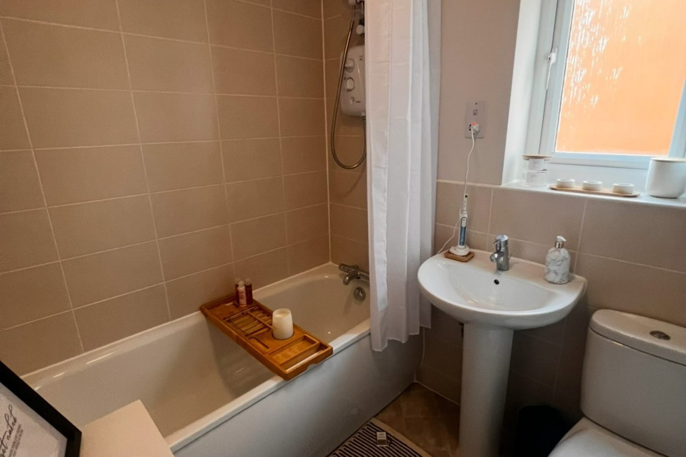 Bathroom with bath shelf over the bath