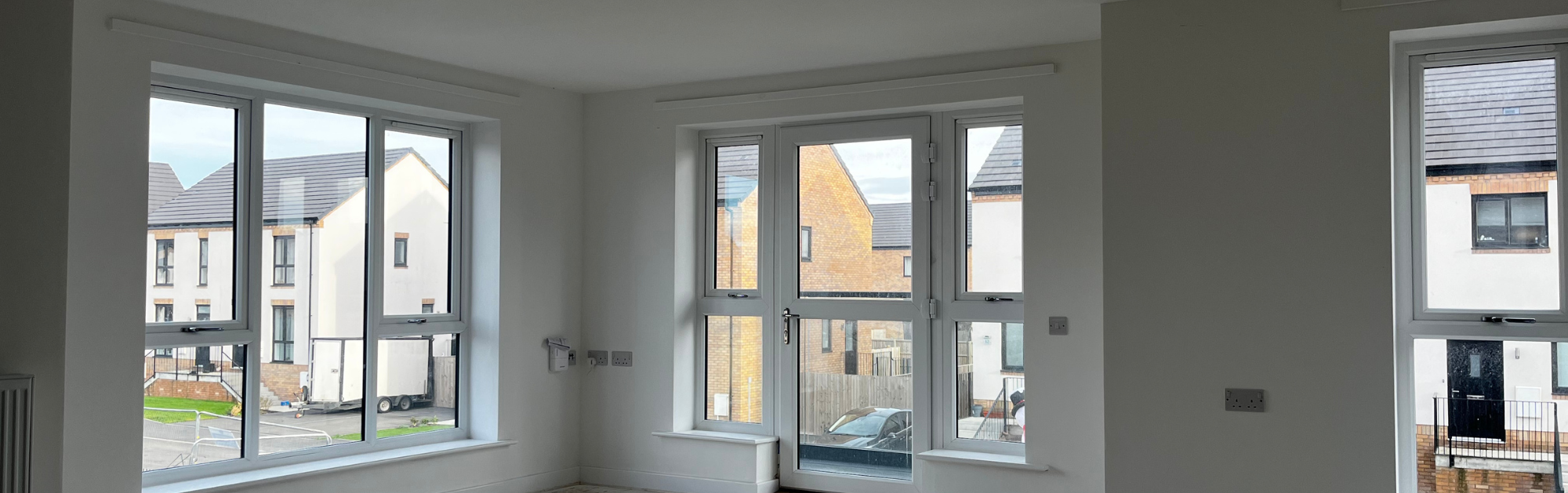 Inside of an apartment with windows and a balcony