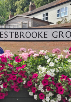 Westrbooke Grove street sign with flowers around it