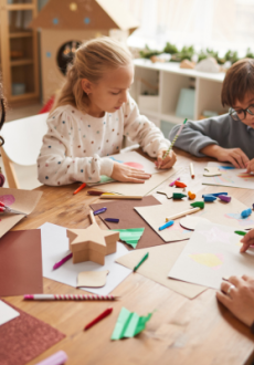 Children doing festive crafts around the table