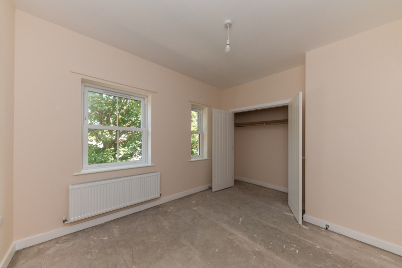 Bedroom with windows and built in wardrobe