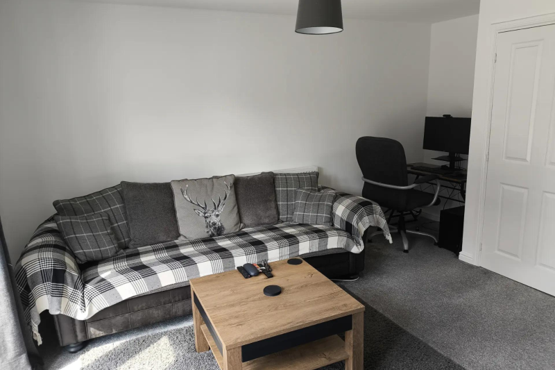 Sofa and coffee table with a desk in the background