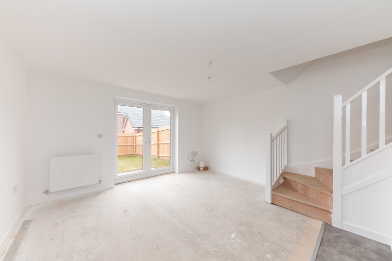 Living room with patio doors out to the garden and stairs