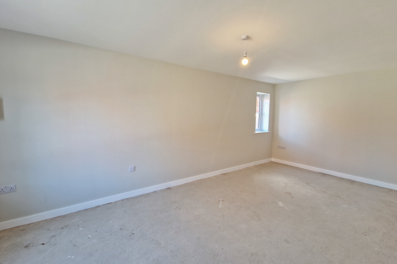 Empty bedroom space with white walls