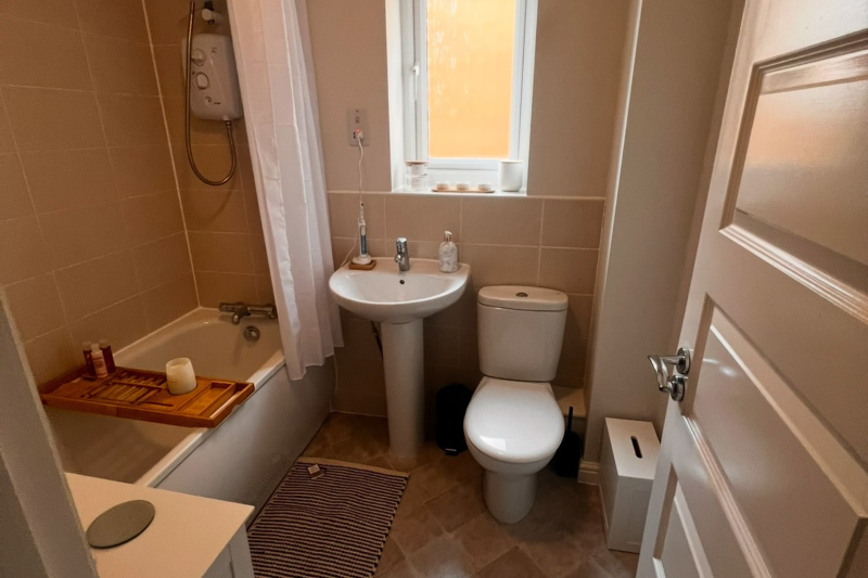 Bathroom with a shower over the bath