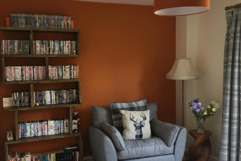 Lounge space with armchair and bookcase