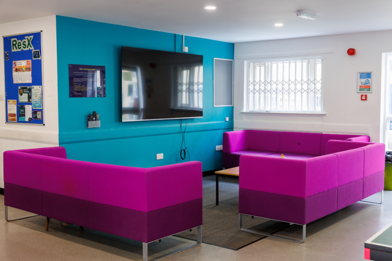 Common room space with sofas and TV