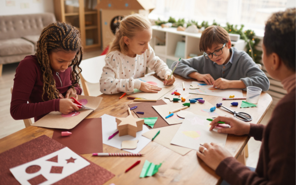 Children doing festive crafts around the table